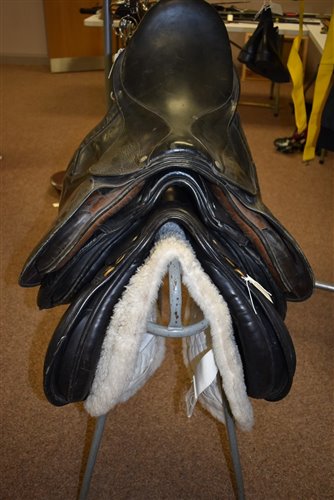 Lot 200 - Three saddles and a stand