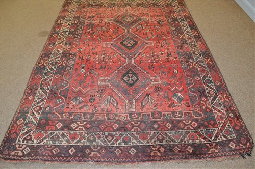 Lot 673 - A South West Persian rug, the red field with...