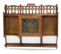 Lot 733 - Manner of Shapland & Petter: an Arts & Crafts oak wall unit.