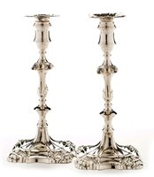 Lot 422 - A pair of George III candlesticks.
