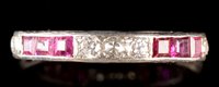 Lot 547 - Ruby and diamond eternity ring