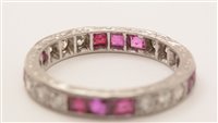 Lot 547 - Ruby and diamond eternity ring