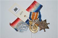 Lot 747 - First World War medals and a badge