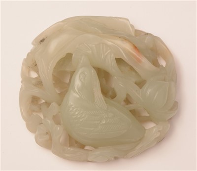 Lot 39 - An early 20th Century Chinese carved pale green jade pendant, and a hardstone disc.
