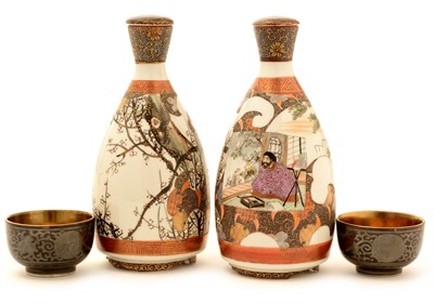 Lot 53 - A pair of early 20th Century Japanese Kutani porcelain Sake bottles and stoppers.