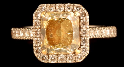 Lot 593 - Fancy light yellow diamond and diamond cluster ring