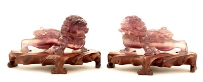 Lot 36 - A pair of 20th Century Chinese amethyst quartz stylised ceremonial lions.