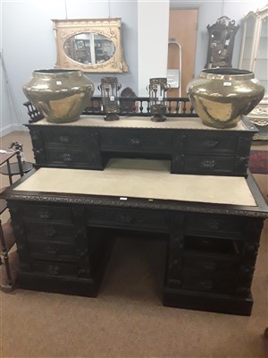 Lot 593 - A large heavily carved stained oak desk.