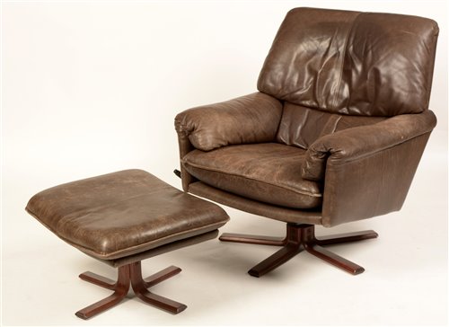 Lot 93 - Trivona Design: a mid/late 20th Century leather armchair and matching footstool.