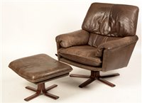 Lot 93a - Trivona Design: a mid/late 20th Century leather armchair and matching footstool.
