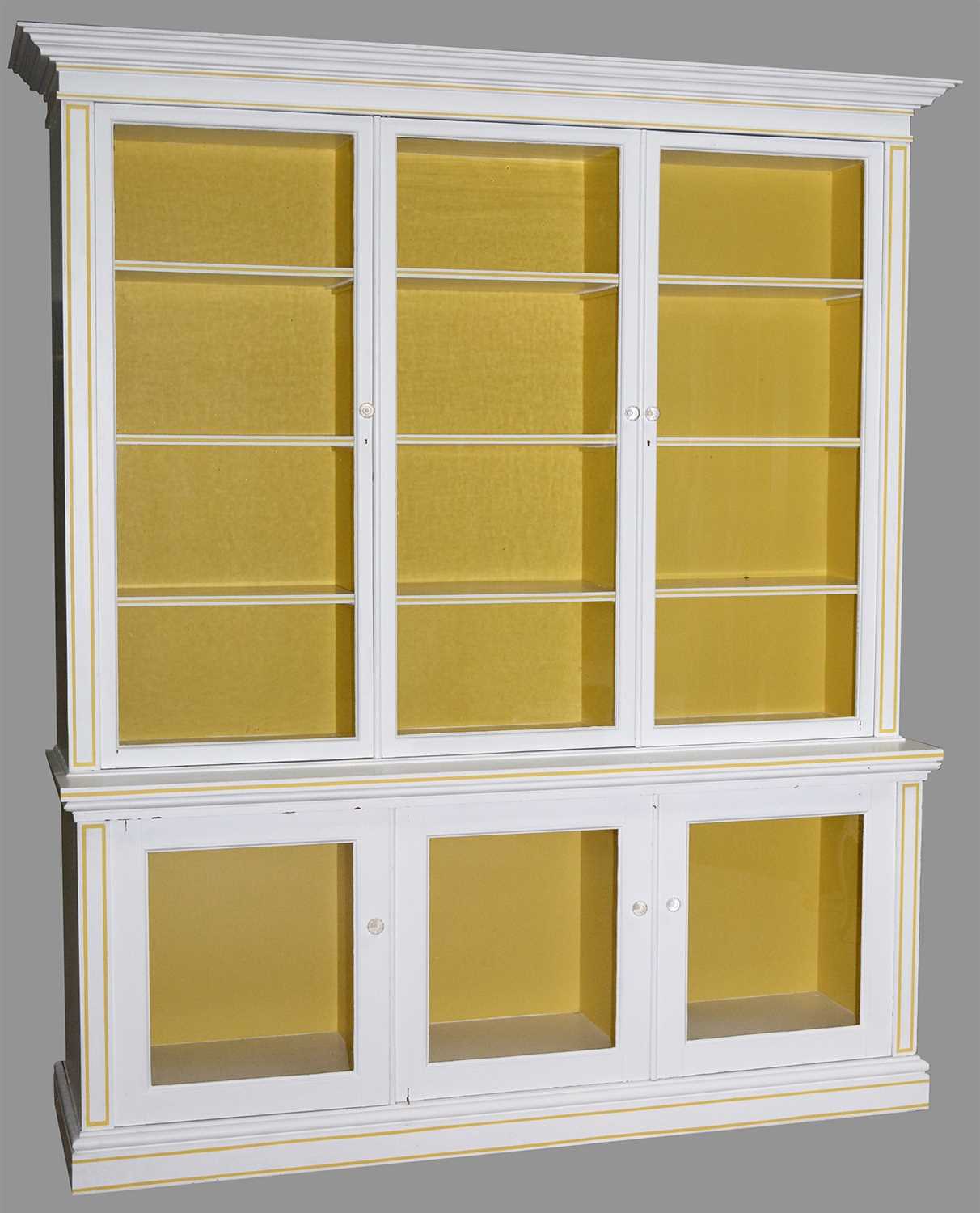 Lot 768 - A large white painted display cabinet.