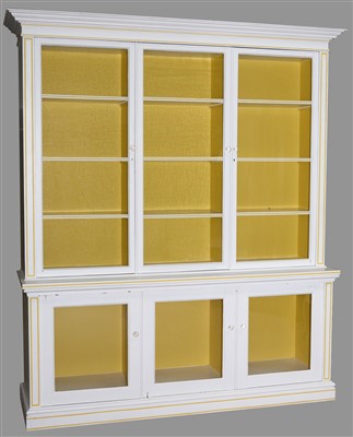 Lot 768 - A large white painted display cabinet.