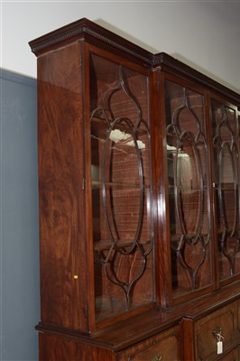 Lot 794 - A George III mahogany breakfront secretaire bookcase.