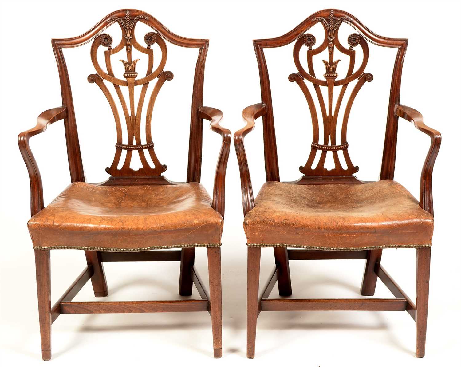 Lot 756 - A near identical pair of George III mahogany armchairs.
