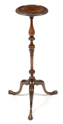 Lot 821 - A carved and stained beechwood tripod jardiniere stand.