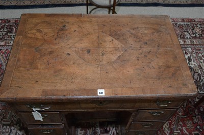 Lot 841 - A walnut kneehole desk.