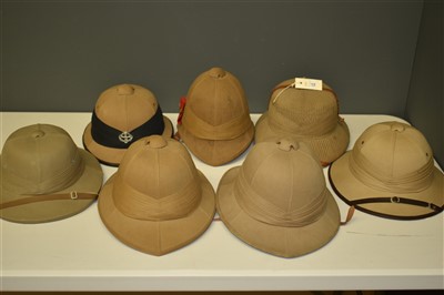 Lot 12 - Seven pith helmets
