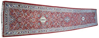 Lot 897 - Sarough runner, with foliate scrolls on red...