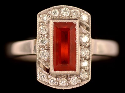 Lot 168 - Orange stone and diamond ring