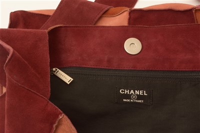 Lot 1489 - Chanel: A suede hand bag, in claret, brown and...