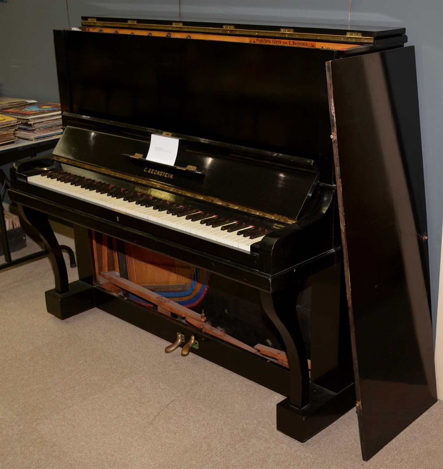 Lot 104 - An ebonised upright piano.