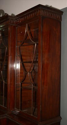 Lot 1226 - A George III mahogany breakfront secretaire bookcase.