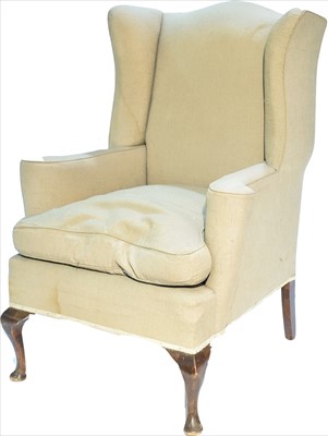 Lot 1111 - A Georgian style wing back armchair.