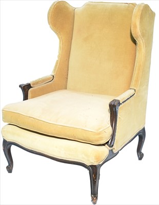 Lot 1112 - A wing back armchair in the French taste.