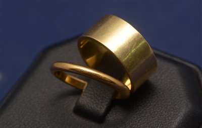 Lot 555 - 22ct gold wedding band, 3g; and a yellow metal...