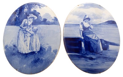 Lot 593 - A pair of blue and white oval plaques