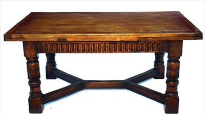 Lot 1157 - A reproduction oak draw leaf refectory style dining table