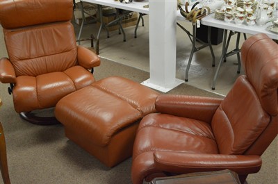 Lot 439 - Two leather armchairs and footstool/storage box.