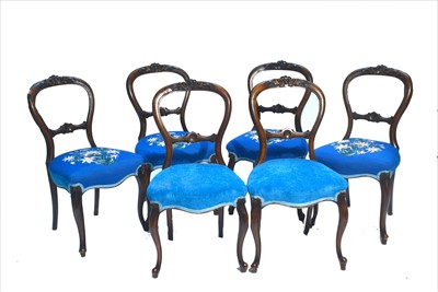 Lot 1166 - A set of six Victorian carved walnut balloon back dining chairs.