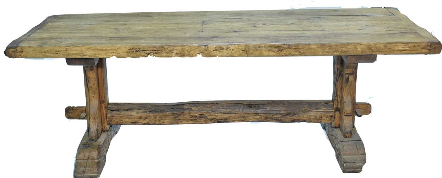 Lot 1165 - A substantial rustic oak dining table.