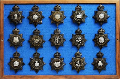 Lot 798 - A collection of 20th Century police helmet badges, framed.