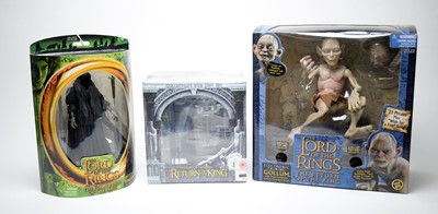 Lot 718 - Three Lord of the Rings action figures and DVD set