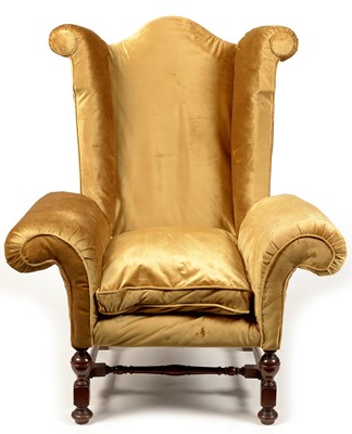 Lot 1105 - A Queen Anne style wing-back armchair