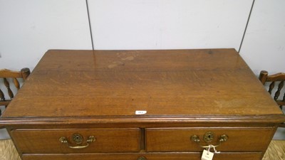 Lot 393 - George III oak chest of drawers
