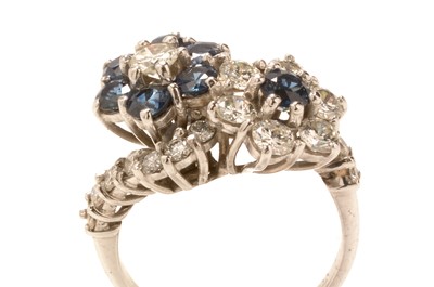 Lot 232 - Sapphire and diamond cluster ring.