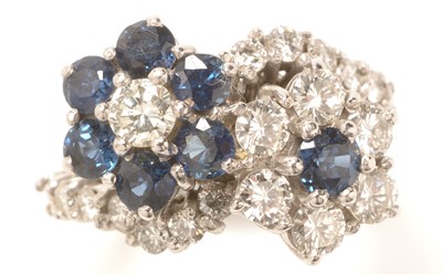 Lot 232 - Sapphire and diamond cluster ring.