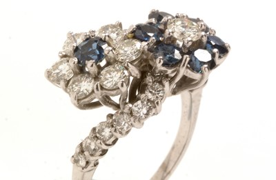 Lot 155 - Sapphire and diamond cluster ring.