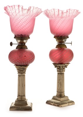 Lot 702 - Pair of electroplate lamps with pink and white shades
