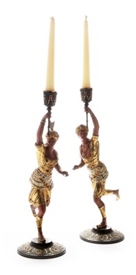 Lot 681 - A pair of early 20th Century figural candlesticks