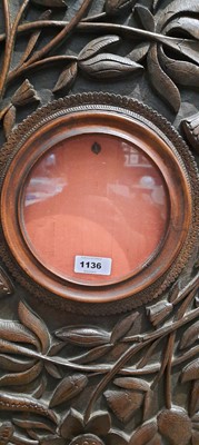 Lot 1136 - An Arts & Crafts circular frame, carved with...
