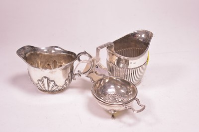 Lot 60 - Two silver jugs and a tea strainer on stand