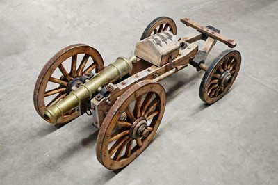 Lot 728 - Reproduction brass and elm cannon.
