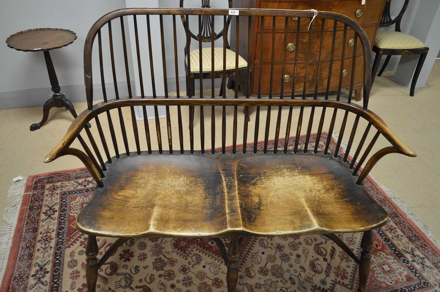 Lot 619 - A Windsor style two-seater settee.