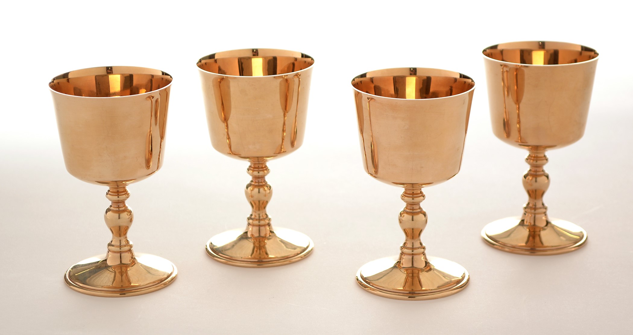 Mgoblets Lot 268 - A set of four 9ct yellow gold goblets