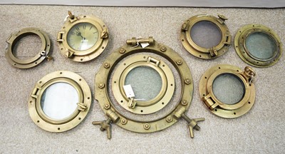 Lot 789 - Six brass portholes; two porthole glasses; and a porthole frame.