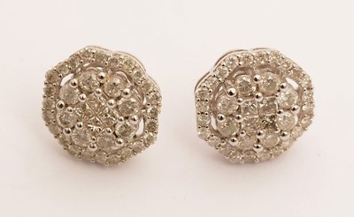 Lot 101 - A pair of diamond cluster earrings